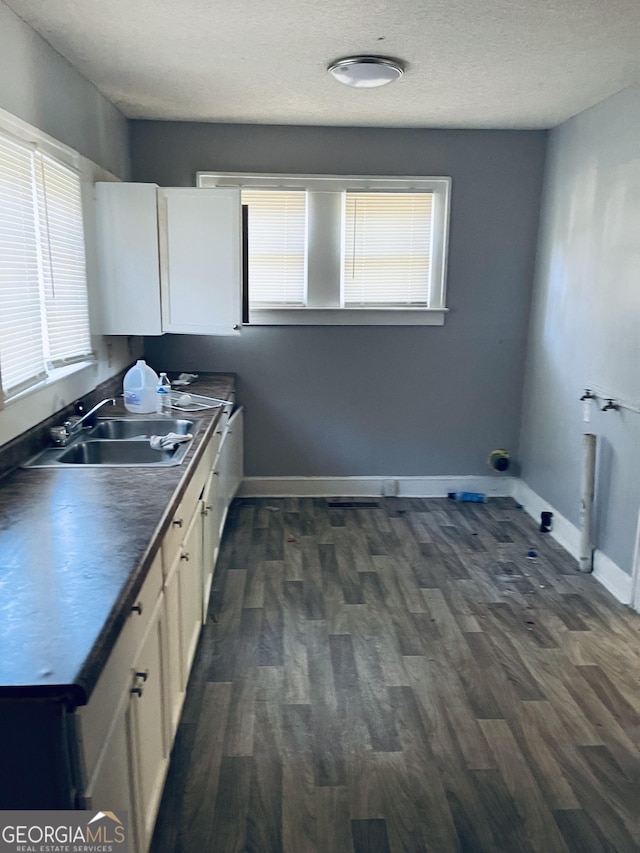 kitchen featuring white cabinetry, sink, and dark hardwood / wood-style flooring