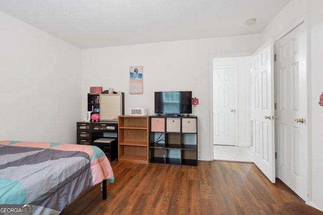 bedroom with dark hardwood / wood-style floors