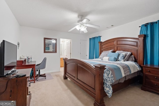 bedroom featuring light carpet, a textured ceiling, and ceiling fan