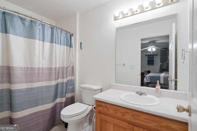 bathroom with vanity, toilet, and a textured ceiling