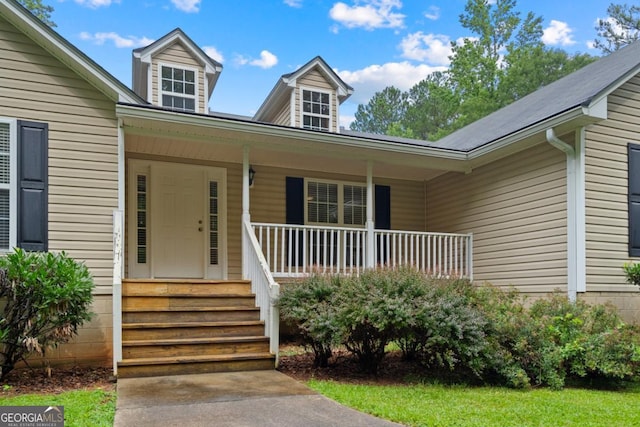 view of exterior entry with a porch