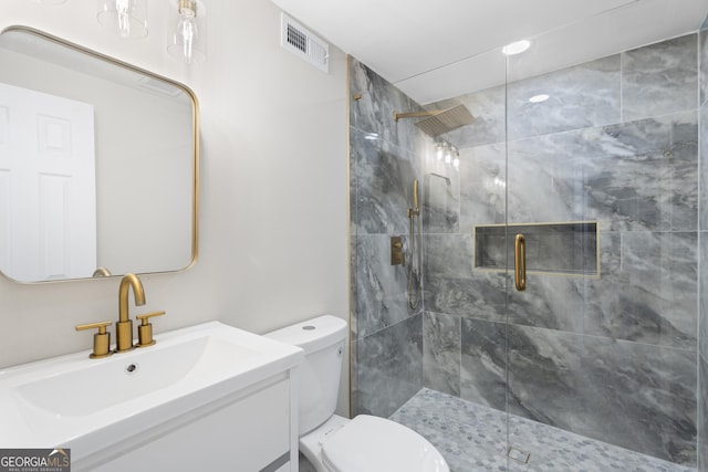 full bath featuring visible vents, toilet, tiled shower, and vanity