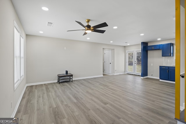 unfurnished living room featuring recessed lighting, visible vents, light wood-style flooring, and baseboards