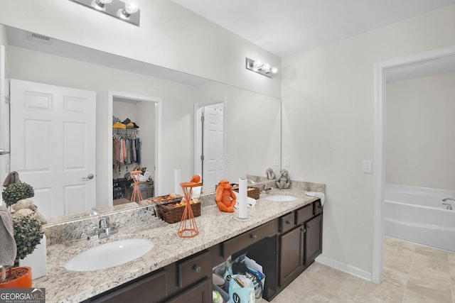 bathroom featuring vanity and a bath