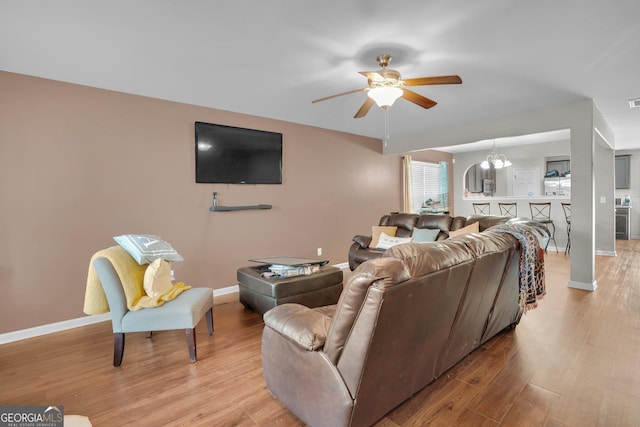 living room with ceiling fan and light hardwood / wood-style floors