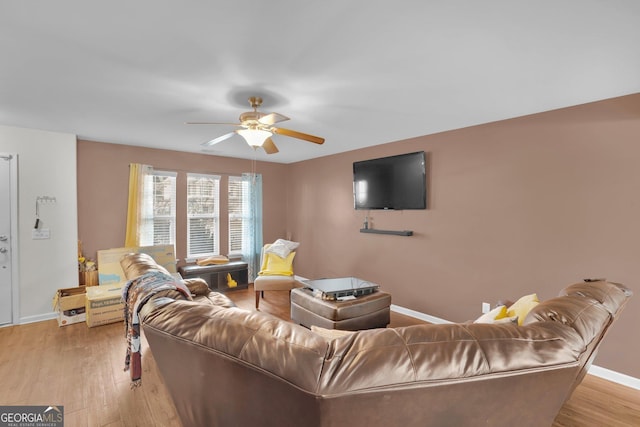 living room featuring light hardwood / wood-style flooring and ceiling fan