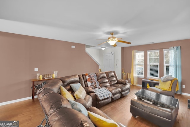 living room with light hardwood / wood-style floors and ceiling fan