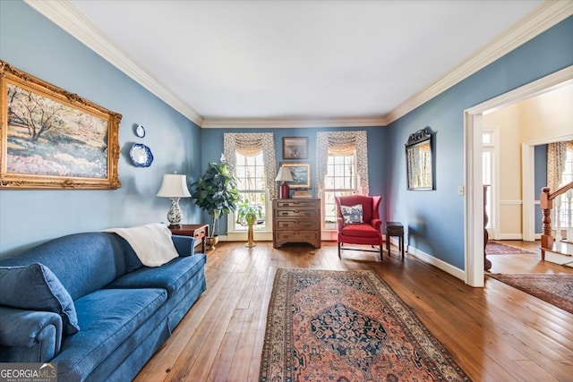 living room with hardwood / wood-style floors and crown molding