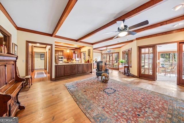 living room with beam ceiling, light hardwood / wood-style flooring, french doors, and ceiling fan