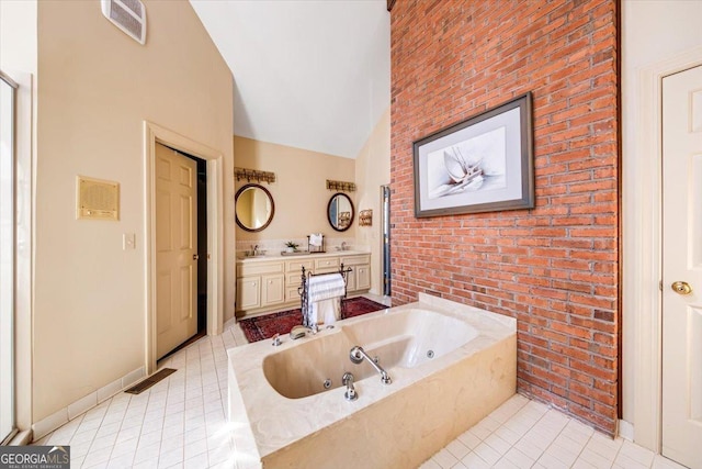 bathroom with tile patterned flooring, high vaulted ceiling, vanity, brick wall, and a tub to relax in