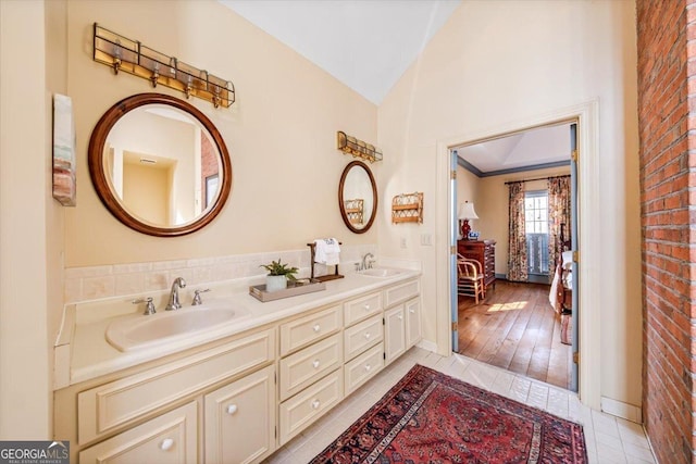 bathroom with vanity and vaulted ceiling