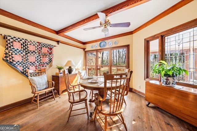 dining room with crown molding, ceiling fan, beam ceiling, and hardwood / wood-style floors