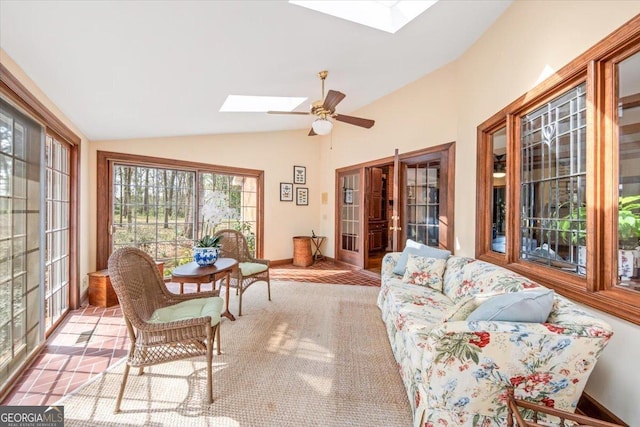 sunroom with ceiling fan and vaulted ceiling with skylight