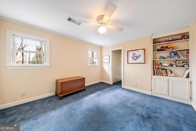 spare room featuring crown molding, ceiling fan, and dark carpet