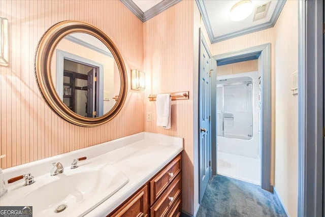 bathroom with vanity, crown molding, and a shower