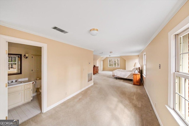 bedroom with light colored carpet, ornamental molding, ensuite bathroom, and sink