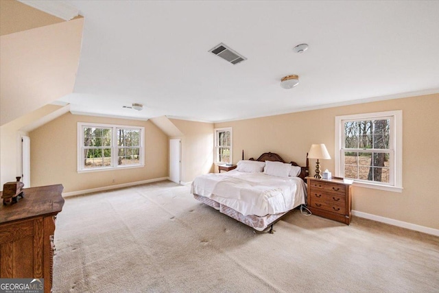 bedroom with light colored carpet, lofted ceiling, and ornamental molding