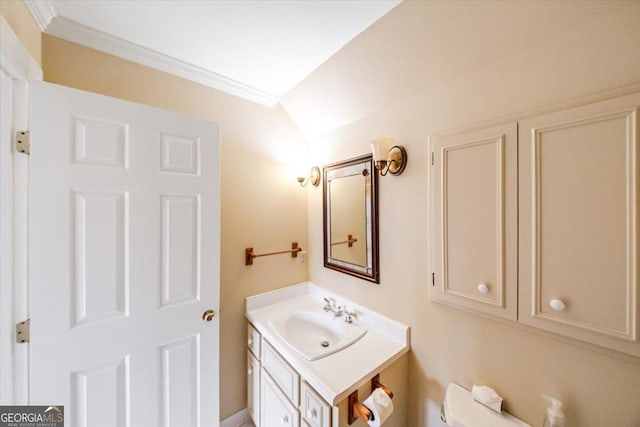 bathroom featuring vanity, ornamental molding, and toilet