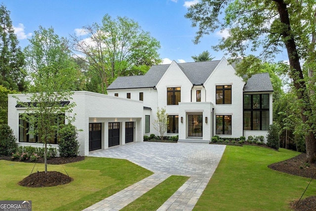 view of front of house with a garage and a front yard