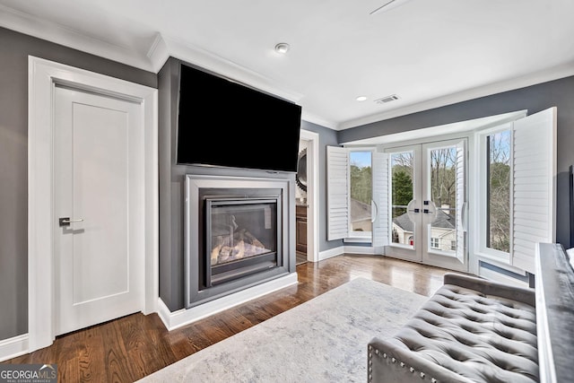 living room with french doors, crown molding, and dark hardwood / wood-style flooring