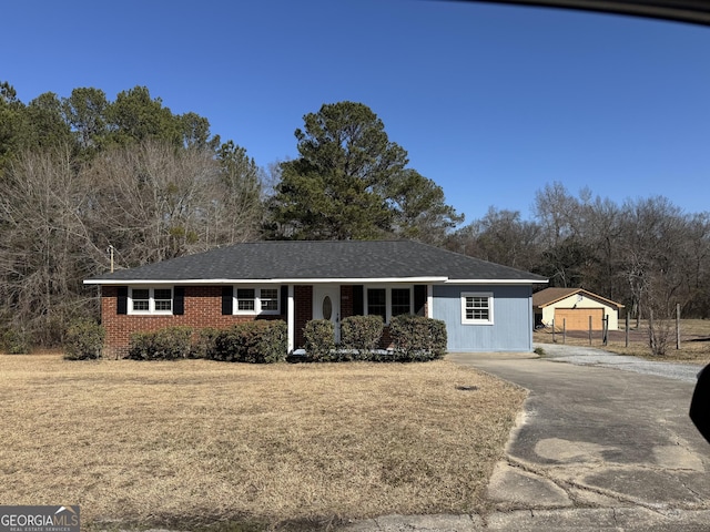 single story home with a garage and a front lawn