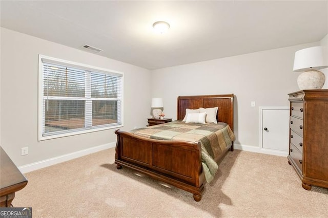 bedroom with visible vents, light carpet, and baseboards