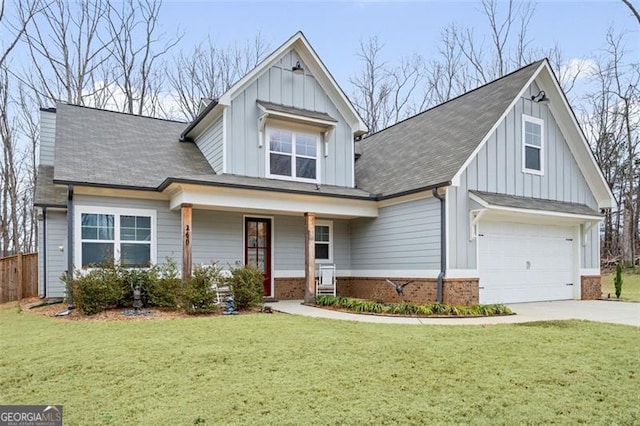 view of front of home with brick siding, concrete driveway, a porch, board and batten siding, and a front yard