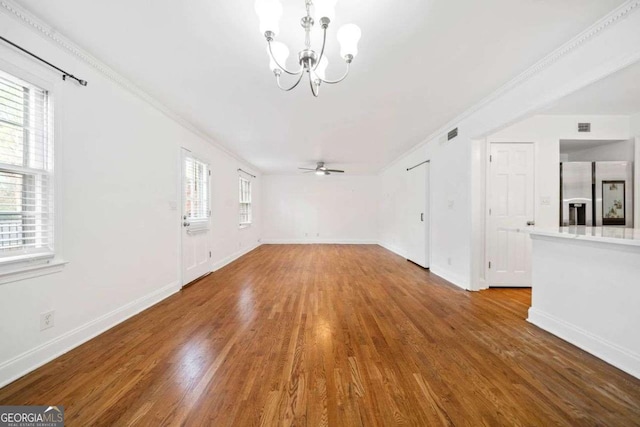 unfurnished living room featuring hardwood / wood-style floors, crown molding, and a wealth of natural light