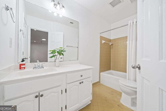 full bathroom featuring vanity, toilet, and tiled shower / bath combo