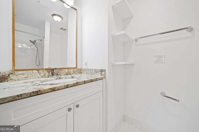 bathroom featuring vanity and a tile shower