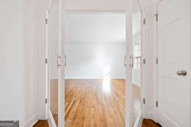 hall with hardwood / wood-style flooring