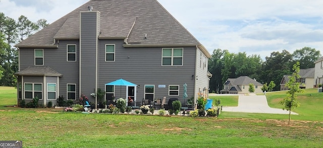 rear view of house with a yard