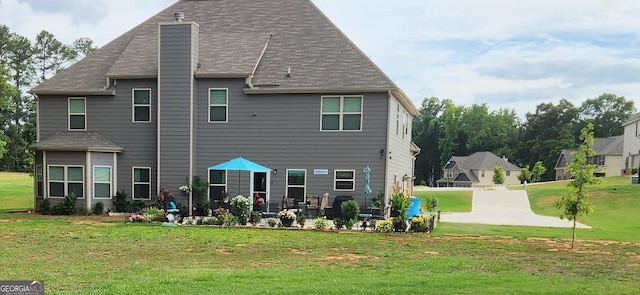 128 Lavender Way Lot 75, Mcdonough, GA 30252 - rear view of house with a chimney and a lawn
