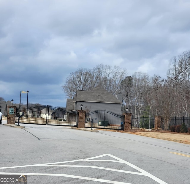 128 Lavender Way Lot 75, Mcdonough, GA 30252 - view of asphalt street with a gate and a gated entry