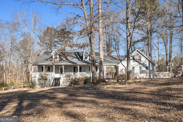 new england style home featuring covered porch