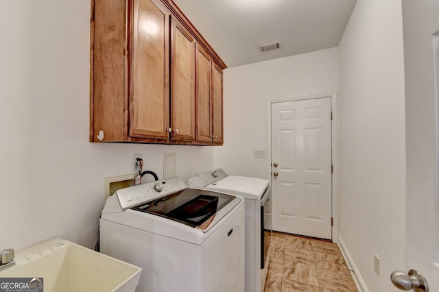 laundry area with cabinets, sink, and washer and dryer