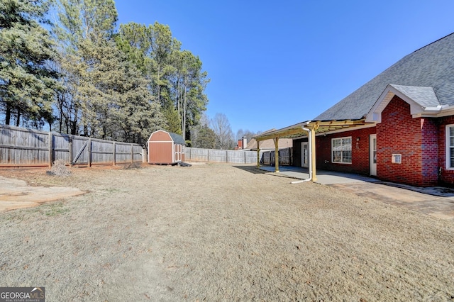 view of yard with a patio and a shed