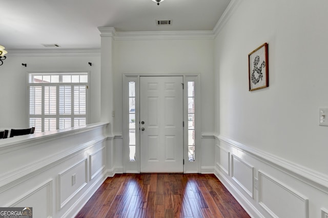 foyer entrance featuring crown molding and dark wood-type flooring