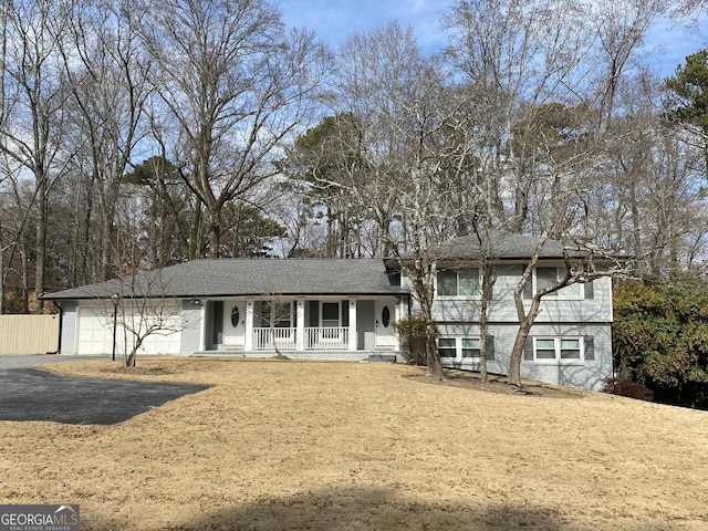 split level home with a garage and a porch