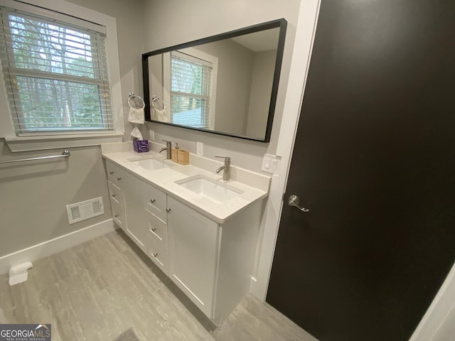 bathroom with vanity and hardwood / wood-style floors