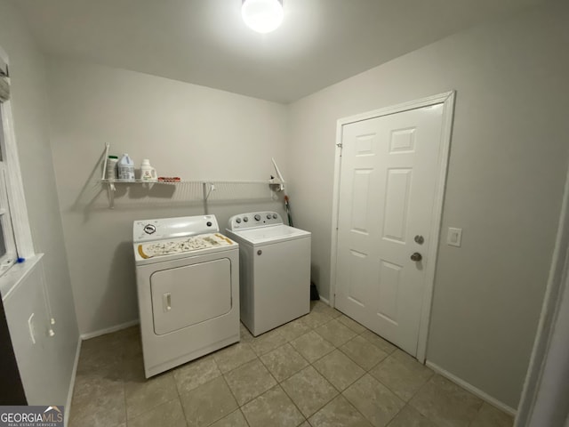 clothes washing area featuring light tile patterned floors and independent washer and dryer