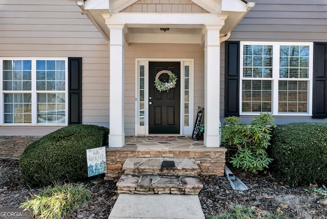 doorway to property featuring covered porch