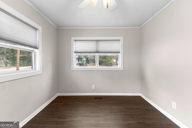 empty room featuring ornamental molding, dark hardwood / wood-style floors, and ceiling fan