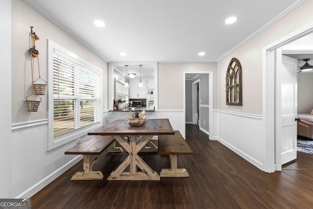 dining area featuring ornamental molding and dark hardwood / wood-style flooring