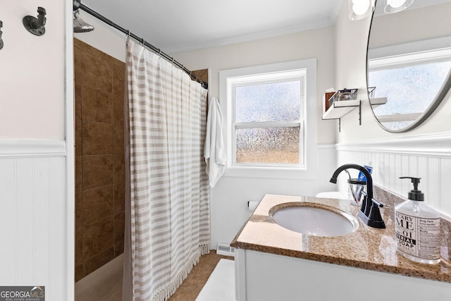 bathroom featuring crown molding, vanity, and walk in shower