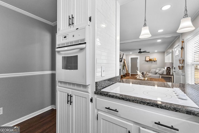 kitchen featuring hanging light fixtures, white appliances, ornamental molding, and white cabinets