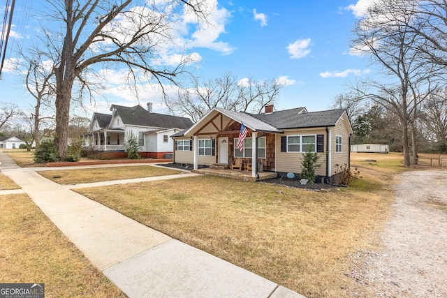 bungalow-style house with a front lawn and a porch