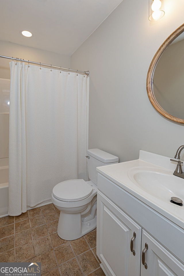 full bathroom with vanity, shower / bath combination with curtain, and toilet