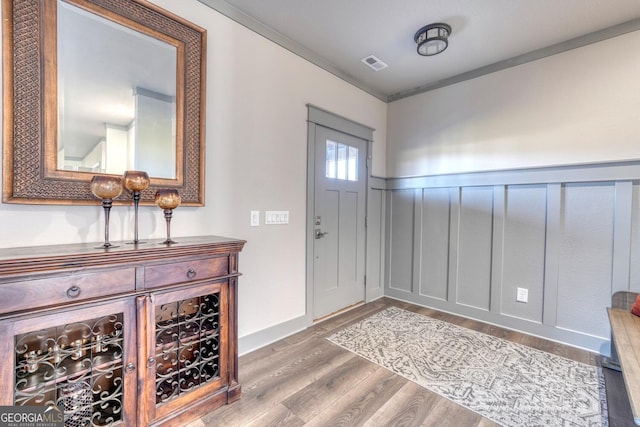 entryway featuring crown molding and wood-type flooring