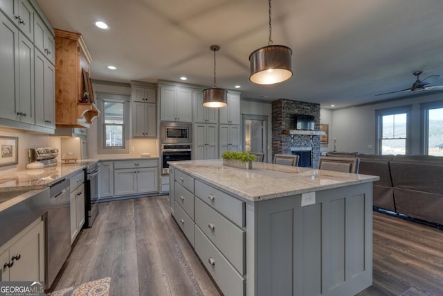 kitchen with gray cabinetry, pendant lighting, and stainless steel appliances